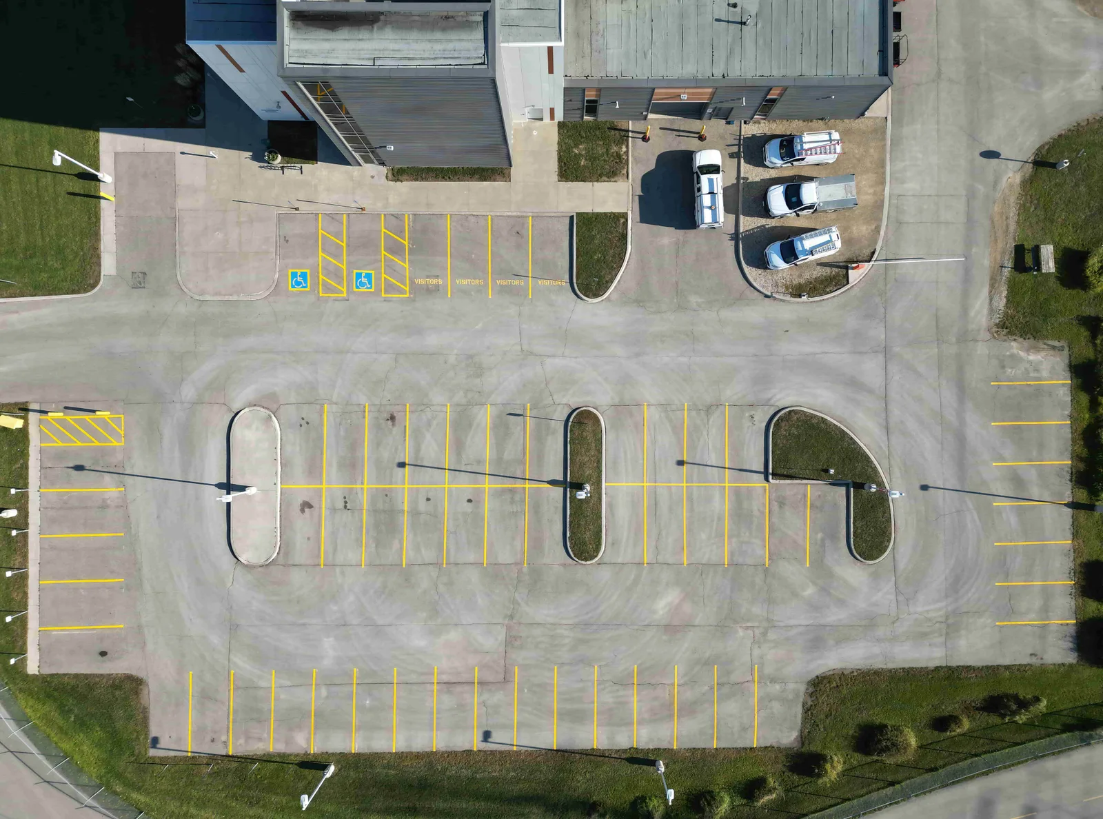 Yellow parking stalls and accessible parking markings on a commercial lot